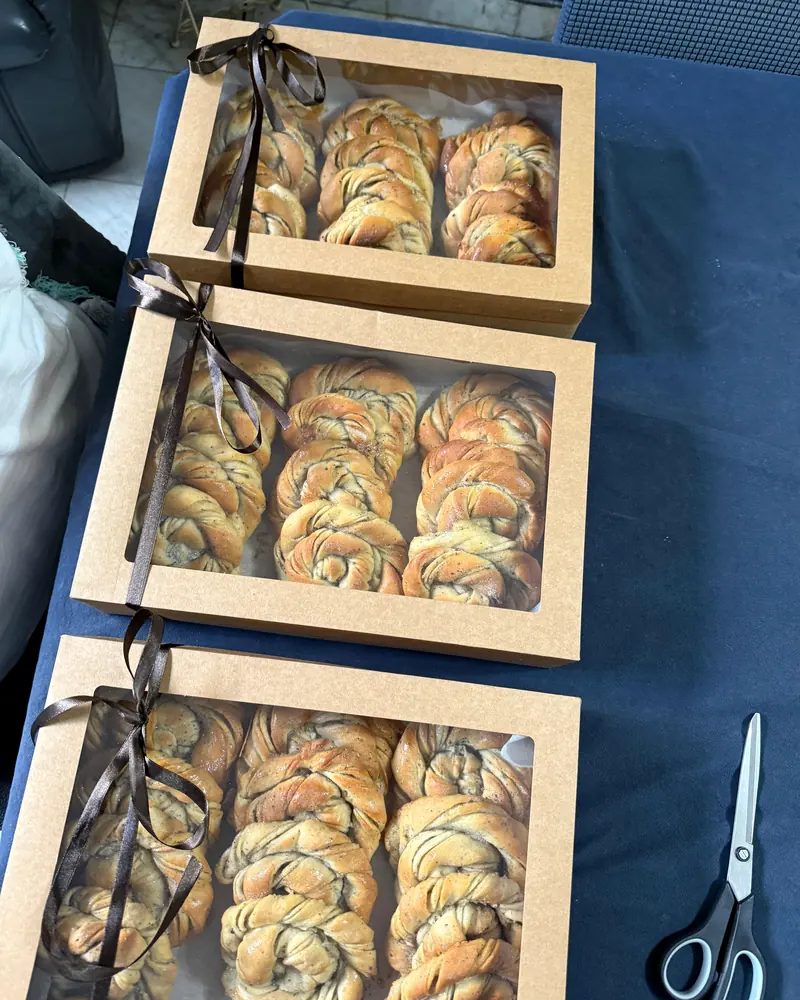 Three kraft gift boxes of buns tied with brown ribbons