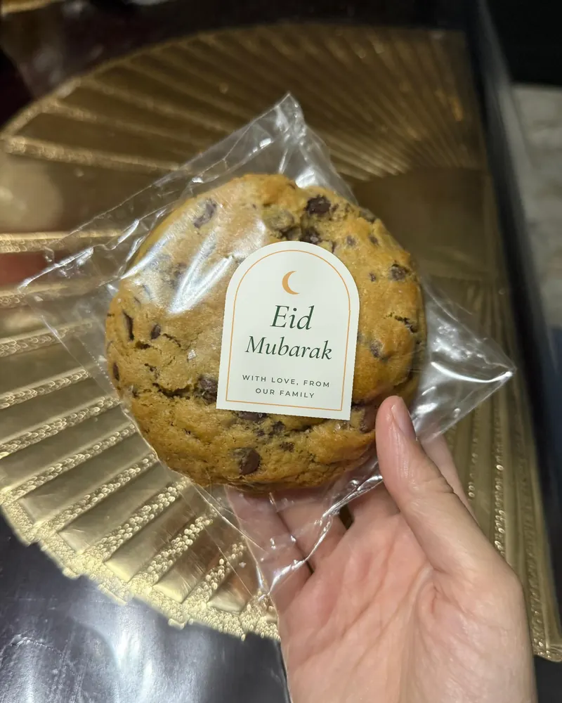 A wrapped cookie with an arch-shaped sticker reading Eid Mubarak