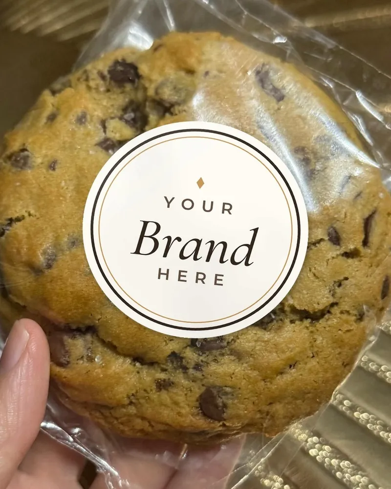A wrapped cookie with a round sticker reading Your Brand Here